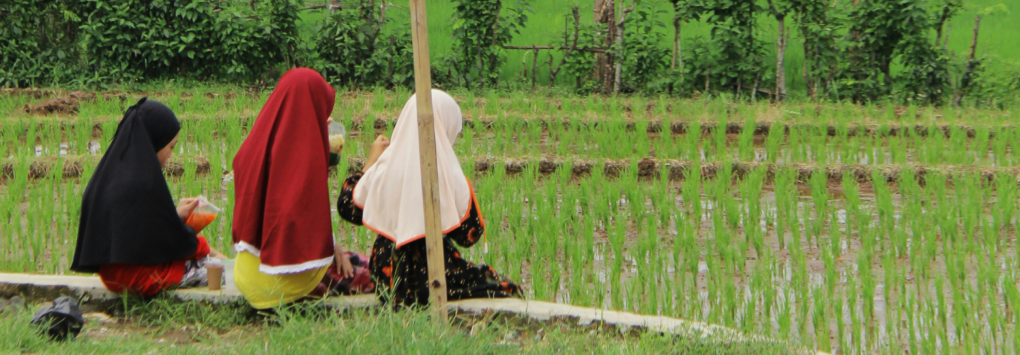 women sitting side road Indonesia